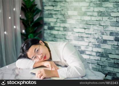 Handsome young businesswoman sleep at home with laptop on desk