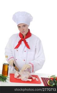 Handsome young chef in uniform prepares chicken. Isolated on white background