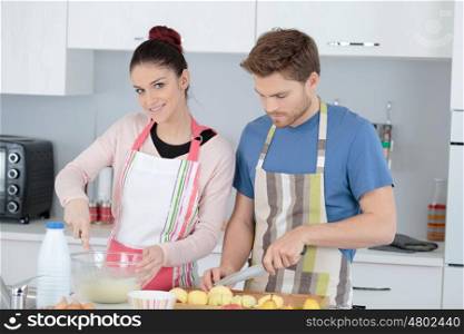 handsome young couple cooking at home