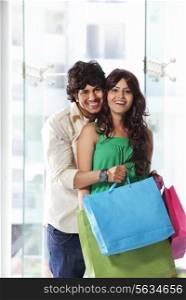 Handsome young couple smiling while shopping