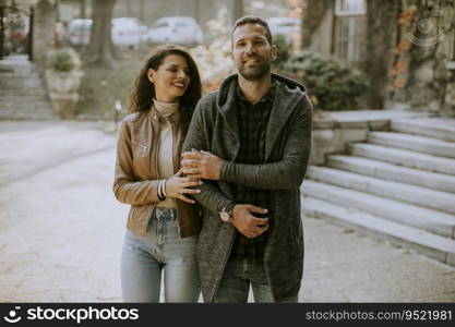 Handsome young couple walking in autumn park