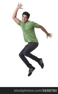 Handsome young guy jumping over white background