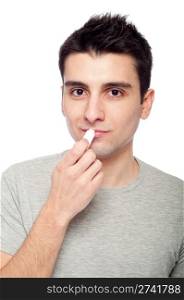 handsome young man applying lip balm (isolated on white background)