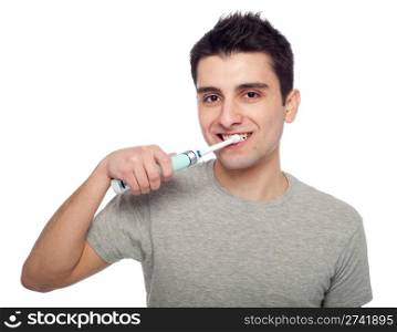 handsome young man brushing his teeth with electric toothbrush (isolated on white background)