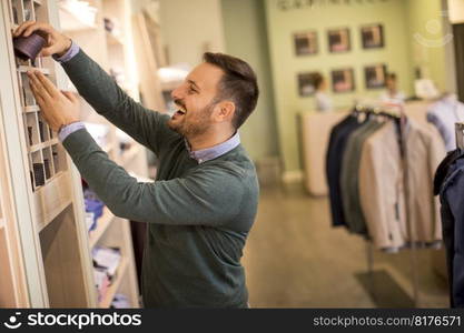 Handsome young man buying nektie in the store