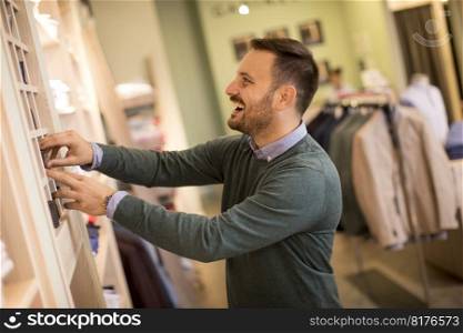Handsome young man buying nektie in the store