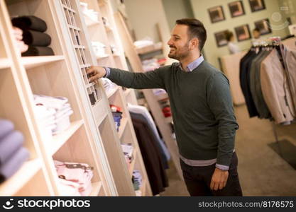 Handsome young man buying nektie in the store