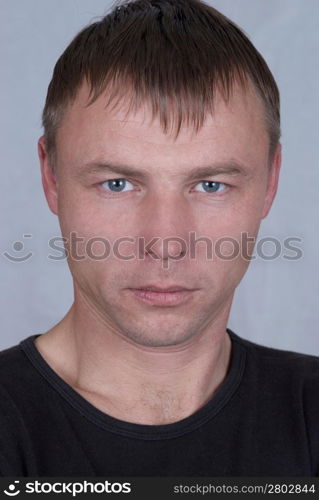 Handsome young man close up portrait on gray background