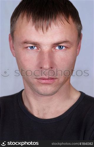 Handsome young man close up portrait on gray background