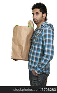 Handsome young man doing his grocery shopping