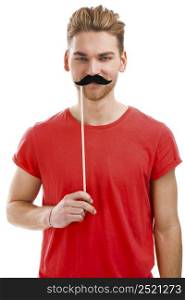 Handsome young man holding a fake moustache in front of his hace