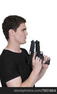 Handsome young man holding a hand gun pistol