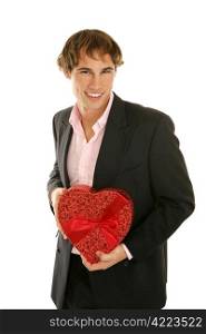 Handsome young man holding a heart shaped box of valentine candy. Isolated on white.