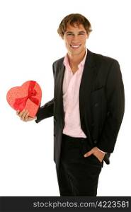 Handsome young man holding a heart shaped box of Valentine candy. Isolated on white.