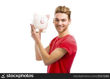 Handsome young man holding a piggy bank and smiling