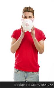 Handsome young man holding a piggy bank and smiling