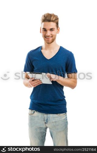 Handsome young man holding and working with a tablet