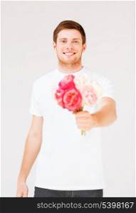 handsome young man holding bouquet of flowers