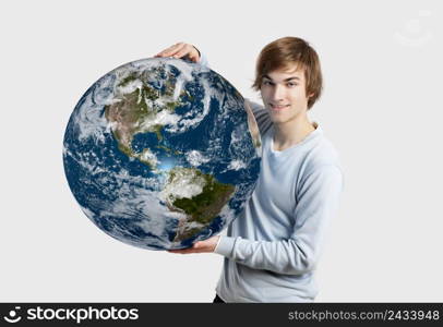 Handsome young man holding the planet earth on its hands, isolated on white