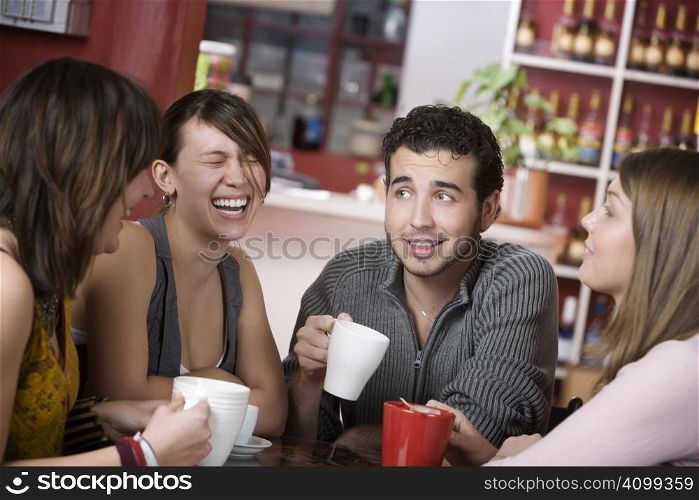 Handsome young man in a coffee house surrounded by pretty women
