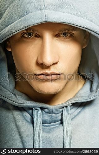Handsome young man in a hood