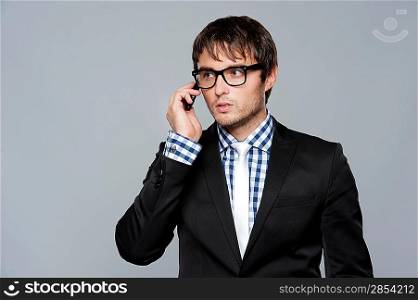 Handsome young man in glasses with mobile phone