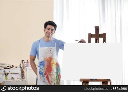 Handsome young man in painting studio