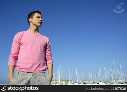 Handsome young man on summer in harbor, blue sky