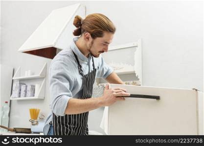 handsome young man opening fridge