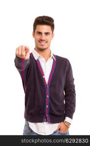 Handsome young man pointing at you, isolated over white background