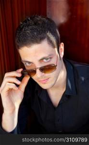 Handsome young man portrait with sunglasses and black shirt