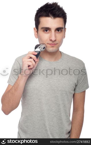 handsome young man shaving with electric shaver (isolated on white background)