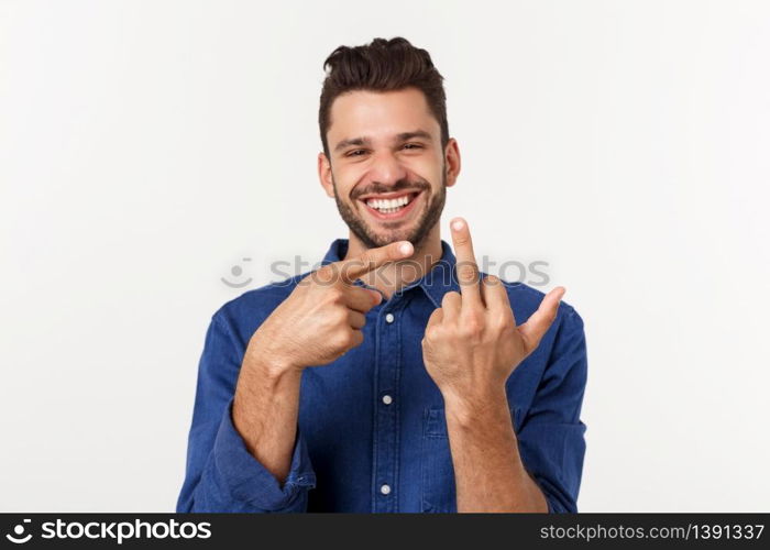 Handsome young man showing middle finger gesturing Screw you with white background. Handsome young man showing middle finger gesturing Screw you with white background.