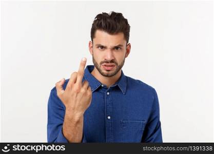 Handsome young man showing middle finger gesturing Screw you with white background. Handsome young man showing middle finger gesturing Screw you with white background.