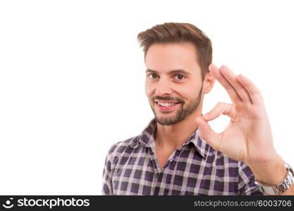 Handsome young man signaling ok, isolated over a white background