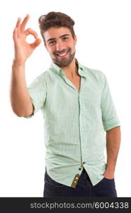 Handsome young man signaling ok, isolated over a white background