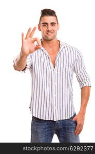 Handsome young man signaling ok, isolated over a white background