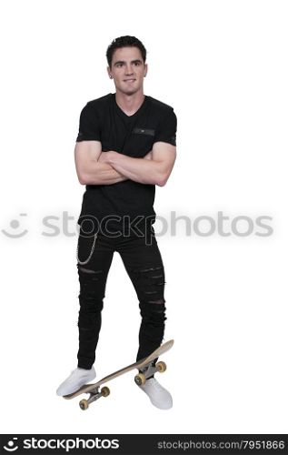 Handsome young man skateboarder with his skateboard