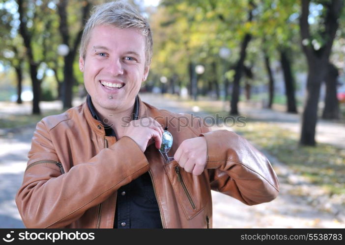 Handsome young man smiling outdoors in nature