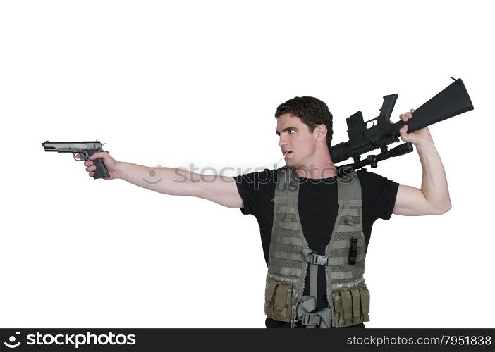 Handsome young man soldier with a pistol and rifle