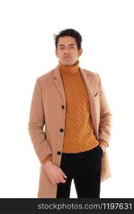 Handsome young man standing in a beige winter coat with one handin his pocket, wearing a sweater, isolated for white background
