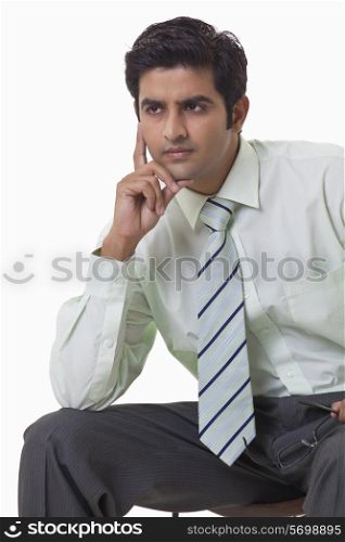 Handsome young man thinking over white background
