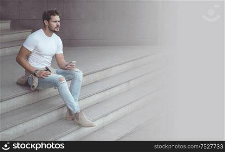 Handsome, young man using a smartphone - downtown shot