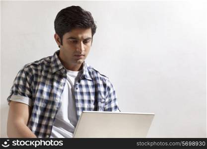 Handsome young man using laptop