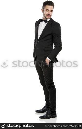 Handsome young man wearing a suit and smiling, isolated on white background