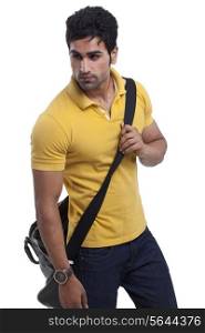 Handsome young man with duffle bag looking away