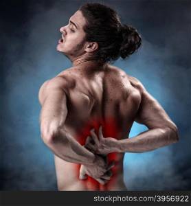 Handsome young man with lower back pain colored in red