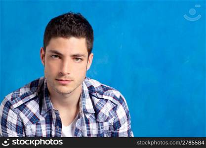 handsome young man with plaid shirt on blue background