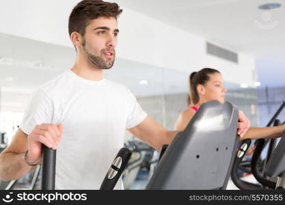 Handsome young man working out at the gym