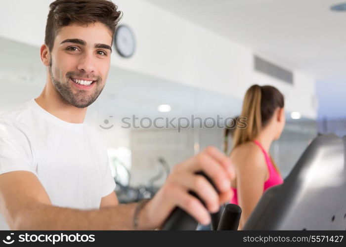 Handsome young man working out at the gym